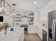Contemporary kitchen featuring an island with seating, stainless steel appliances, and open shelving at 2004 Mohawk Trl, Maitland, FL 32751