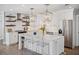 Modern kitchen with white cabinets, open shelving, stainless steel appliances, and marble countertops at 2004 Mohawk Trl, Maitland, FL 32751
