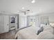 Bright and airy main bedroom with white bedding, a ceiling fan, and access to the backyard at 2004 Mohawk Trl, Maitland, FL 32751