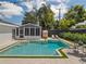Aerial view of a private backyard pool, sunroom, and outdoor dining area perfect for entertaining at 2004 Mohawk Trl, Maitland, FL 32751