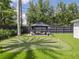 Backyard putting green featuring an outdoor gazebo with seating and manicured landscaping at 2004 Mohawk Trl, Maitland, FL 32751