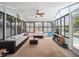 Spacious sunroom filled with natural light features tile flooring and ample seating at 2004 Mohawk Trl, Maitland, FL 32751