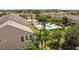A high angle shot showcasing a community of townhomes with a pool and meticulously manicured landscaping at 2012 Gold Spring Cv, Kissimmee, FL 34743