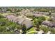 Aerial view of community of well maintained homes, a pool, landscaping, and shady trees at 2012 Gold Spring Cv, Kissimmee, FL 34743