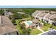 Aerial view of community pool, complex grounds and verdant landscaping, sunny skies above at 2012 Gold Spring Cv, Kissimmee, FL 34743