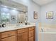 Well-maintained bathroom with a tub, shower, vanity, and a large mirror in a neutral color scheme at 2012 Gold Spring Cv, Kissimmee, FL 34743