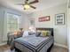 Cozy bedroom featuring a large window and desk area, creating a peaceful and functional space at 2012 Gold Spring Cv, Kissimmee, FL 34743