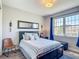 Inviting bedroom with natural lighting, featuring a well-dressed bed and stylish side decor at 2012 Gold Spring Cv, Kissimmee, FL 34743