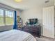 Serene bedroom with a large window and decorative display shelf, offering a relaxing retreat at 2012 Gold Spring Cv, Kissimmee, FL 34743