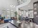 Open dining room featuring high ceilings, large windows, and modern decor with an adjacent kitchen at 2012 Gold Spring Cv, Kissimmee, FL 34743