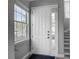 Inviting entryway with a white front door, sidelight window, and a view of the staircase at 2012 Gold Spring Cv, Kissimmee, FL 34743