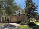 Charming townhome with well-maintained landscaping, a brick driveway, and a two-car garage at 2012 Gold Spring Cv, Kissimmee, FL 34743