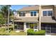 View of the exterior of a condo with a screened lanai, green space and a view of the windows above at 2012 Gold Spring Cv, Kissimmee, FL 34743