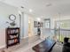 Bright hallway with decorative bookshelf, leading to the living room and other areas of the house at 2012 Gold Spring Cv, Kissimmee, FL 34743