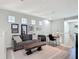 Comfortable living area featuring a gray sofa, decorative coffee table, and a dedicated desk space at 2012 Gold Spring Cv, Kissimmee, FL 34743