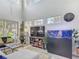 Bright living room featuring large windows, high ceilings, stylish decor, a TV, and an aquarium at 2012 Gold Spring Cv, Kissimmee, FL 34743