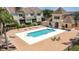 Community pool area featuring lounge chairs and a pool house near the residential buildings at 2012 Gold Spring Cv, Kissimmee, FL 34743