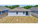 Rear exterior view featuring lawn and patio at 2308 Glenbrook Chase Blvd, Lakeland, FL 33811