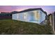 Home's backyard with a covered patio and sliding glass door at 2308 Glenbrook Chase Blvd, Lakeland, FL 33811