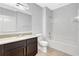 Bathroom with granite vanity and a combination tub and shower with white tile surround at 2308 Glenbrook Chase Blvd, Lakeland, FL 33811