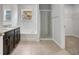 Bathroom featuring a double vanity, separate tub, and glass-enclosed shower at 2308 Glenbrook Chase Blvd, Lakeland, FL 33811