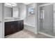 Bathroom showcasing a granite-topped vanity, tub, and a walk-in shower with glass door at 2308 Glenbrook Chase Blvd, Lakeland, FL 33811