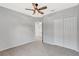 Carpeted bedroom with a ceiling fan, double closets, and view to bathroom at 2308 Glenbrook Chase Blvd, Lakeland, FL 33811