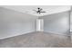 Carpeted bedroom featuring a ceiling fan, neutral walls, and an open doorway at 2308 Glenbrook Chase Blvd, Lakeland, FL 33811