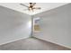 Carpeted bedroom with a ceiling fan, neutral walls, and a bright window at 2308 Glenbrook Chase Blvd, Lakeland, FL 33811