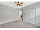 Bedroom with double closets, ceiling fan, and view to ensuite bathroom at 2308 Glenbrook Chase Blvd, Lakeland, FL 33811
