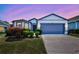 Charming single Gathering home featuring a two-car garage, well manicured lawn, and unique blue trim at 2308 Glenbrook Chase Blvd, Lakeland, FL 33811