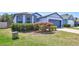 Charming single Gathering home featuring a two-car garage, well manicured lawn, and unique blue trim at 2308 Glenbrook Chase Blvd, Lakeland, FL 33811