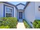 Inviting front entrance with a well-maintained walkway and lush landscaping, leading to a modern, blue front door at 2308 Glenbrook Chase Blvd, Lakeland, FL 33811