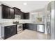 Well-equipped kitchen with dark wood cabinetry, granite countertops, and stainless steel appliances at 2308 Glenbrook Chase Blvd, Lakeland, FL 33811
