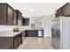 Well-equipped kitchen with dark wood cabinetry, granite countertops, and stainless steel appliances at 2308 Glenbrook Chase Blvd, Lakeland, FL 33811