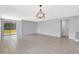 Bright, open-concept living room showcasing tile floors, neutral walls, and sliding glass doors to the backyard at 2308 Glenbrook Chase Blvd, Lakeland, FL 33811