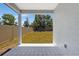 Covered patio featuring modern patterned tiles, overlooking a fenced backyard with ample green space at 2308 Glenbrook Chase Blvd, Lakeland, FL 33811