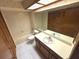 Bathroom features a tub, commode, single sink vanity, and cabinet storage at 2348 Sun Valley Cir, Winter Park, FL 32792