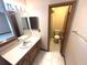 Bathroom featuring a sink, vanity, lighted mirror, and enclosed toilet at 2348 Sun Valley Cir, Winter Park, FL 32792
