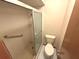 Bathroom features a shower stall, toilet, and grab bar for accessibility at 2348 Sun Valley Cir, Winter Park, FL 32792