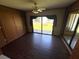 Cozy bedroom featuring wood flooring, a ceiling fan, and a sliding glass door to the backyard at 2348 Sun Valley Cir, Winter Park, FL 32792