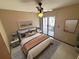Bedroom featuring tile floor, ceiling fan, area rug, Queen bed and glass door to patio at 2348 Sun Valley Cir, Winter Park, FL 32792