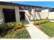 Charming front entryway with covered porch, lush landscaping, and convenient walkway at 2348 Sun Valley Cir, Winter Park, FL 32792