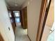 Hallway featuring hardwood floors, baseboards and door trim at 2348 Sun Valley Cir, Winter Park, FL 32792