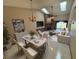 Bright living room with brick fireplace, ceiling fan and skylights and modern dining table at 2348 Sun Valley Cir, Winter Park, FL 32792