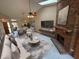 Bright living room featuring a brick fireplace, ceiling fan, skylights, and modern furniture at 2348 Sun Valley Cir, Winter Park, FL 32792