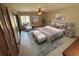 Stylishly staged main bedroom boasts a ceiling fan and tile floors at 2348 Sun Valley Cir, Winter Park, FL 32792
