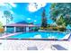 A spacious swimming pool surrounded by lounge chairs and lush greenery at 2348 Sun Valley Cir, Winter Park, FL 32792