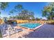 Community pool with many lounge chairs surrounded by a wooden fence at 2348 Sun Valley Cir, Winter Park, FL 32792