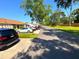 Scenic street view of townhomes and well-maintained lawns with mature trees and parked cars at 2348 Sun Valley Cir, Winter Park, FL 32792